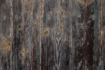 Texture of old dark wood with traces of peeling paint