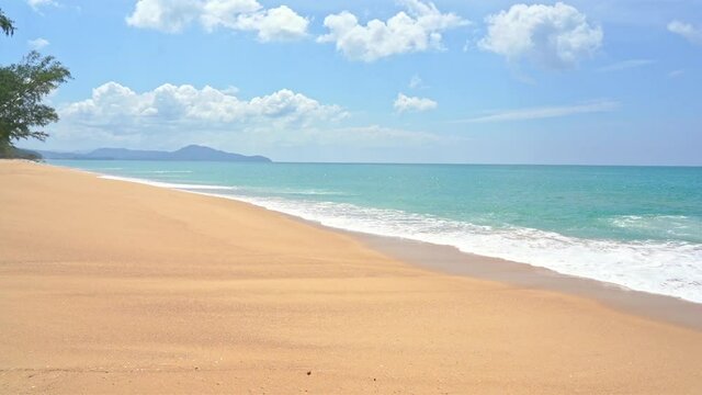 Wild island - Empty yellow sandy beach line and turquoise sea water, Slow calm sea tides and cloudy sky without people tree, Generic, static, mountains on background