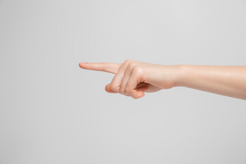 The female hand shows the index finger to the side.