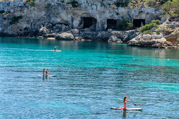 Paddle surf in front of the caves of Portals Vells, Calvia, Mallorca, Balearic Islands, Spain