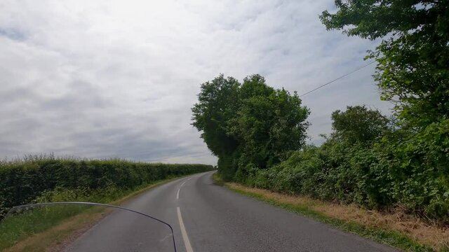 Car cutting corner on bend dangerous just  misses motorcycle .