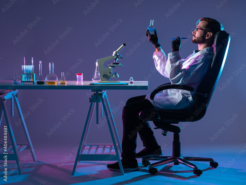 Poster chemist in profile at the desk. the chemist at the table is removed from the side. the scientist eva