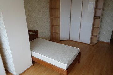 Room with a bed furnished in basic style