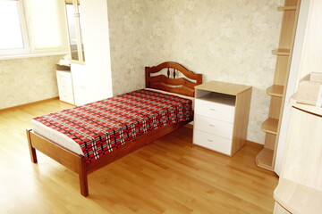 Room with a bed furnished in basic style