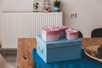Blue and pink gift boxes on wooden table. to buy gifts for loved ones.