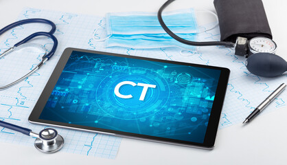 Close-up view of a tablet pc with CT abbreviation, medical concept