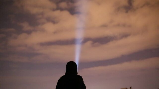 The man who lights the sky with a flashlight. cold weather search and rescue signal