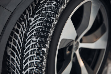 Car tires on winter road covered with snow