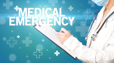 doctor writes notes on the clipboard with MEDICAL EMERGENCY inscription, first aid concept