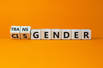 Transgender or cisgender symbol. Turned wooden cubes and changed word 'cisgender' to 'transgender'. Beautiful orange background, copy space. Transgender or cisgender concept.