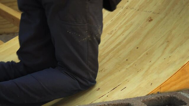 Flattening wooden ramp deck manually with human weight closeup