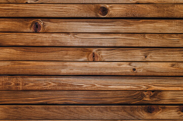 Fototapeta na wymiar Texture of brown old wood with knots. Natural boards in wood stain.