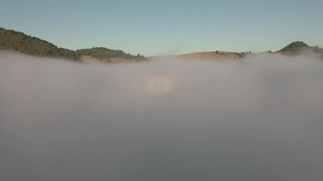 drone flying inside of a cloud