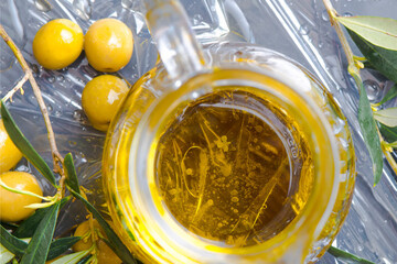 Extra virgin olive oil and olives, closeup.