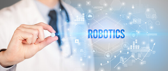 Doctor giving a pill with ROBOTICS inscription, new technology solution concept