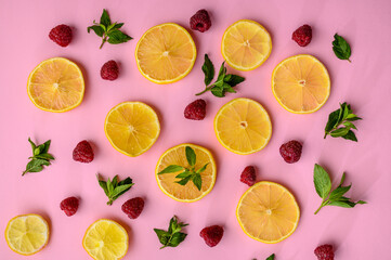 Lemon slices and strawberries on purple background