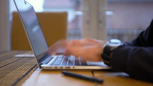 Young man working from home typing fast (Time Lapse) on his laptop in the kitchen. Super quick productivity shot showing time pausing and work being completed. 

1080P 25FPS 10bit SLOG2-REC709
