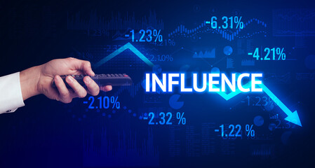 male hand holding wireless peripheral with INFLUENCE inscription, modern business concept