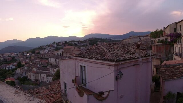 Altomonte , Calabria Summer panoramic view on the pink town colored by the sunset. Shift left camera movement