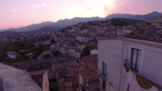 Slowly revealing Altomonte view from top on sunset. Tilt up camera movement