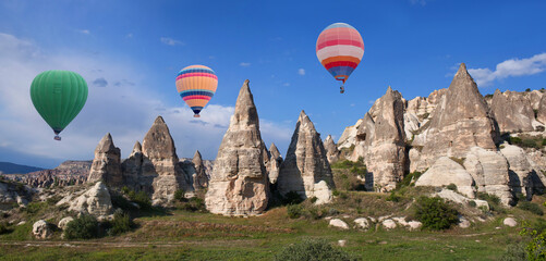 Colorful hot air balloons flying in blue sky over Cappadocia, Central Anatolia, Turkey
