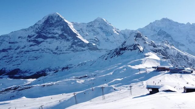 a beautiful ski area in the foreground, eiger, m&ouml;nch and jungfrau in the background, lots of snow and sun! (switzerland)