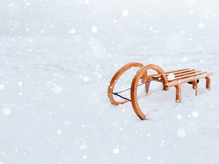 Vintage classic wooden sled for snow riding and sledding - winter fun and games