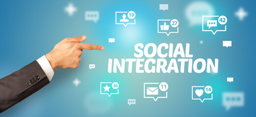 Close-Up of cropped hand pointing at SOCIAL INTEGRATION inscription, social networking concept