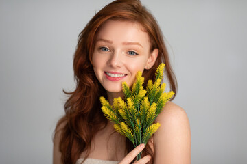 Beautiful Red-Haired Young Lady Posing With Plant Over Gray Background