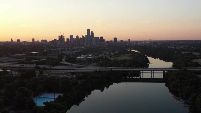 A Golden Sunrise backlighting Austin's downtown Skyline and a busy mopac expressway