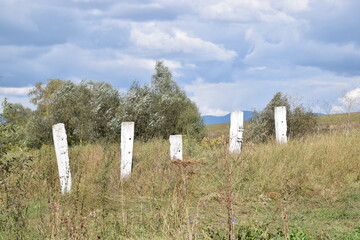 Railroad ties used as roadblock in a field