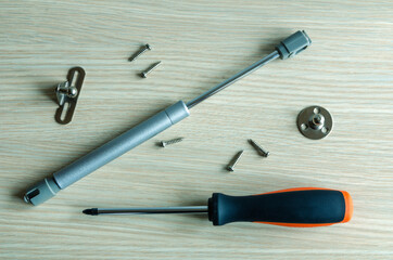 The master assembles and installs a gas-oil lift rack on furniture.