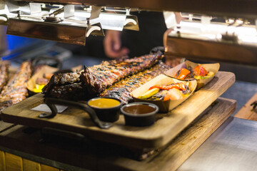 Fried pork ribs with stewed vegetables and sauces.