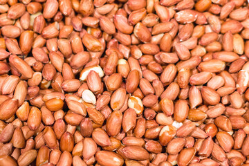 Lots of raw peanuts as background, texture, pattern.