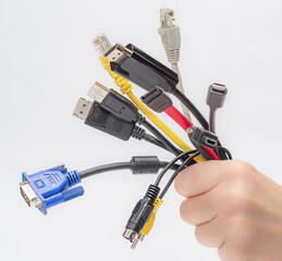 cables in hand isolated on white background. bundle of computer interface cables.