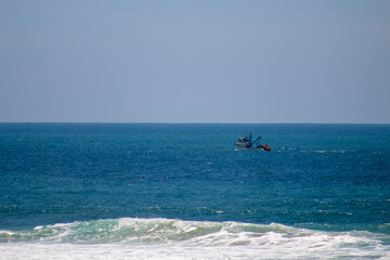 Fototapeta premium boat in the sea Santinho beach, Florianópolis, Santa Catarina, Brazil, Florianópolis
