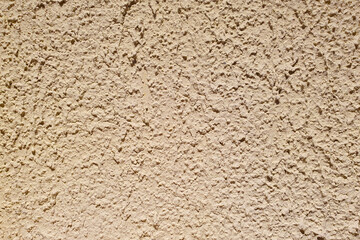 Texture of rough beige stucco wall. Decorative plaster on the wall.