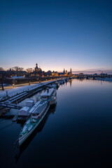 Naklejka premium Vertical Dresden Skyline in Winter, With Elbe River, Boats and Snow