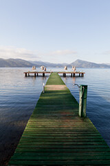 Fototapeta premium Wooden pier extending into the sea allowing you to admire the horizon