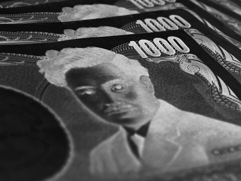 One thousand yen Japanese note field. Focus on number 1000. Bundle of banknotes. Dramatic black and white illustration on the theme of the economic crisis or criminal money. Negative-inverted image