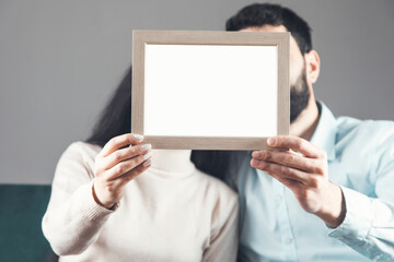 the couple holds frame photo