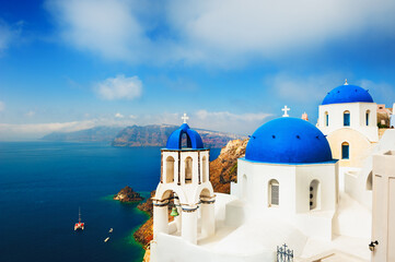 Fototapeta na wymiar Traditional greek church with blue domes in Oia, Santorini island, Greece. Famous travel destination