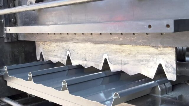 Aluminium roof sheeting being cut into lengths