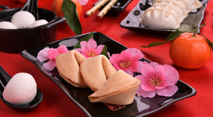 Wish cookies on a red background. Traditional Chinese dinner at the Red Lantern Festival. Filled snacks and rice cakes. High quality photo
