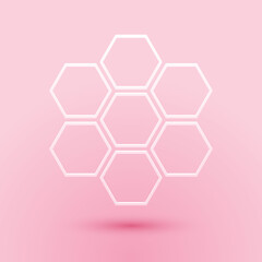Paper cut Honeycomb sign icon isolated on pink background. Honey cells symbol. Sweet natural food. Paper art style. Vector.