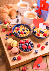 Morning coffee. Aromatic coffee, muesli and sweet pastries for a romantic breakfast. Healthy food with berries and cappuccino for the morning. High quality photo