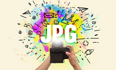 Close-up of a hand holding digital camera with abstract drawing and JPG inscription