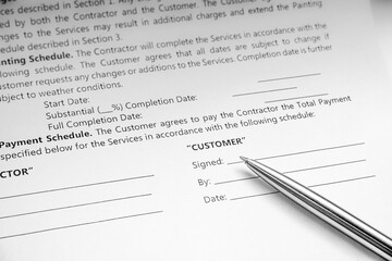 Close-up of a silver pen on docunent contract. Legal contract signing. Buy sell real estate contract agreement. Customer sign on document paper with silver pen