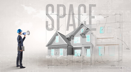 Young engineer holding blueprint with SPACE inscription, house planning concept