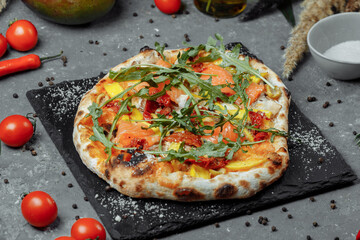 Delicious pizza with salmon and vegetables. italian pizza